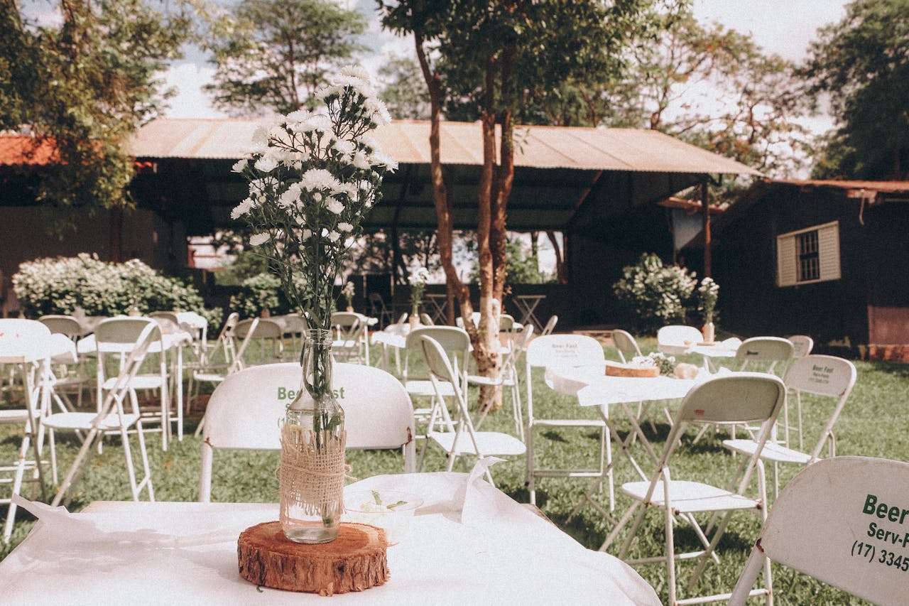 why-choose-us Charming outdoor garden event setup with floral centerpiece on a sunny day.