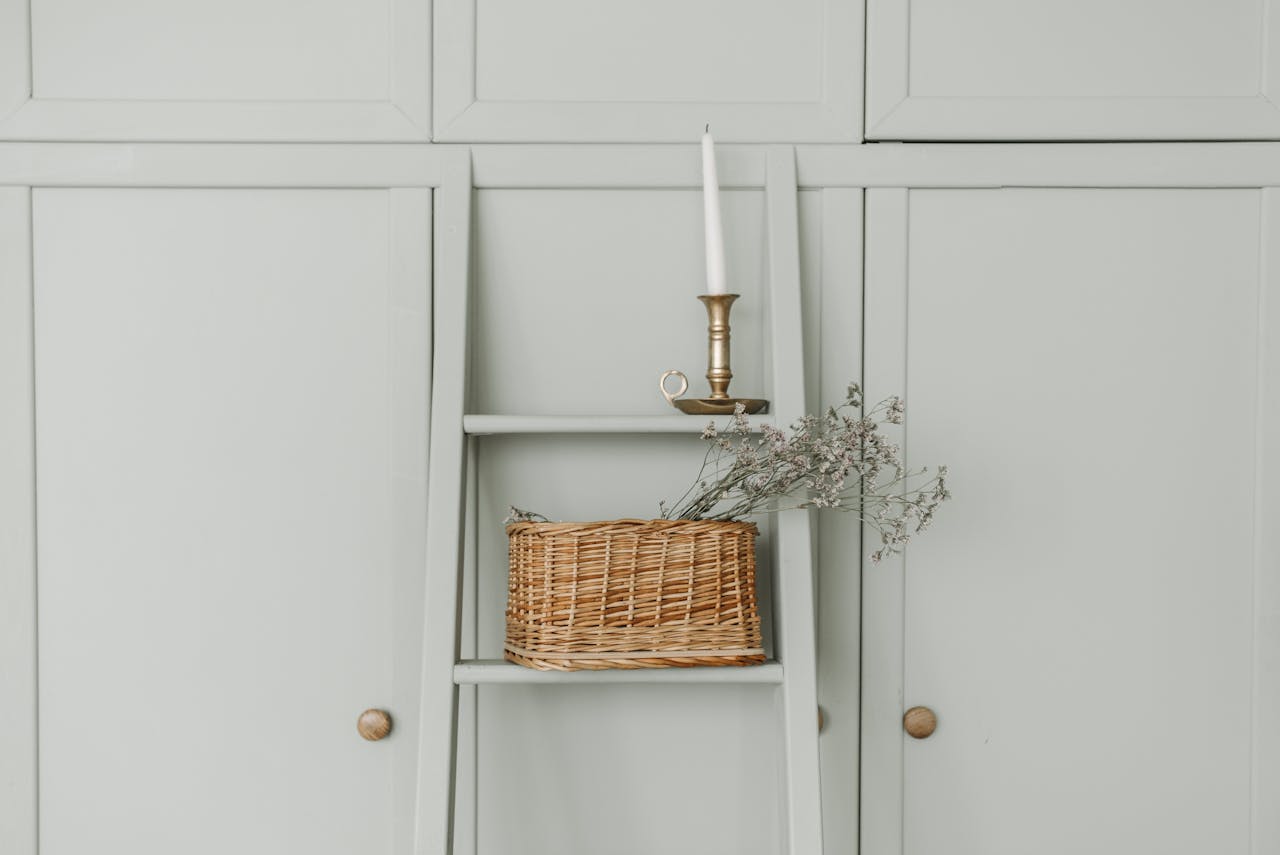contact-img Cozy interior featuring a woven basket with flowers and a candle for an elegant decorative touch.