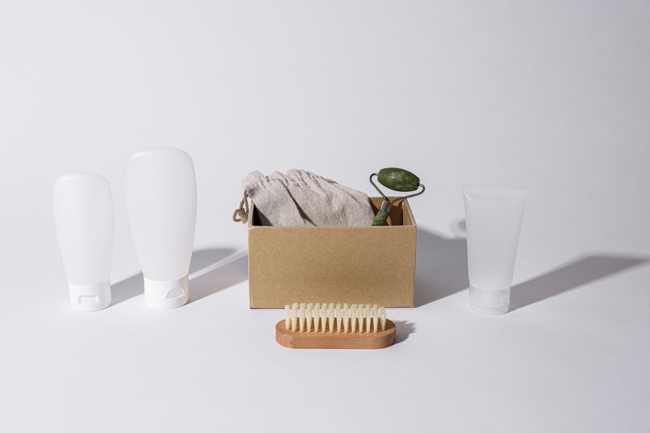 hero-img-02 A minimalist arrangement of eco-friendly skincare products on a white surface.